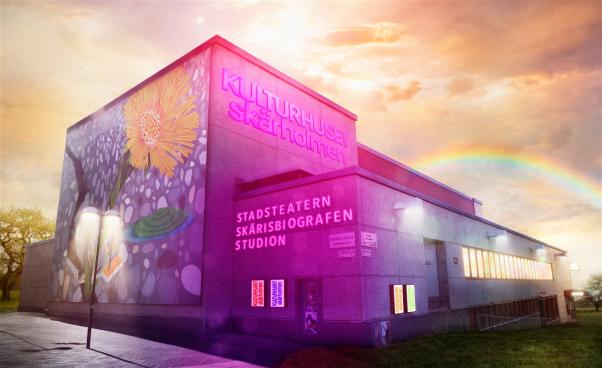 Kulturhuset Skärholmens byggnad upplyst i neon i solljuset med en regnbåge i bakgrunden.