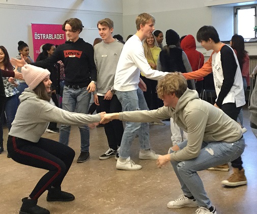 Två personer håller i varandras händer och försöker dra den andre till sig.