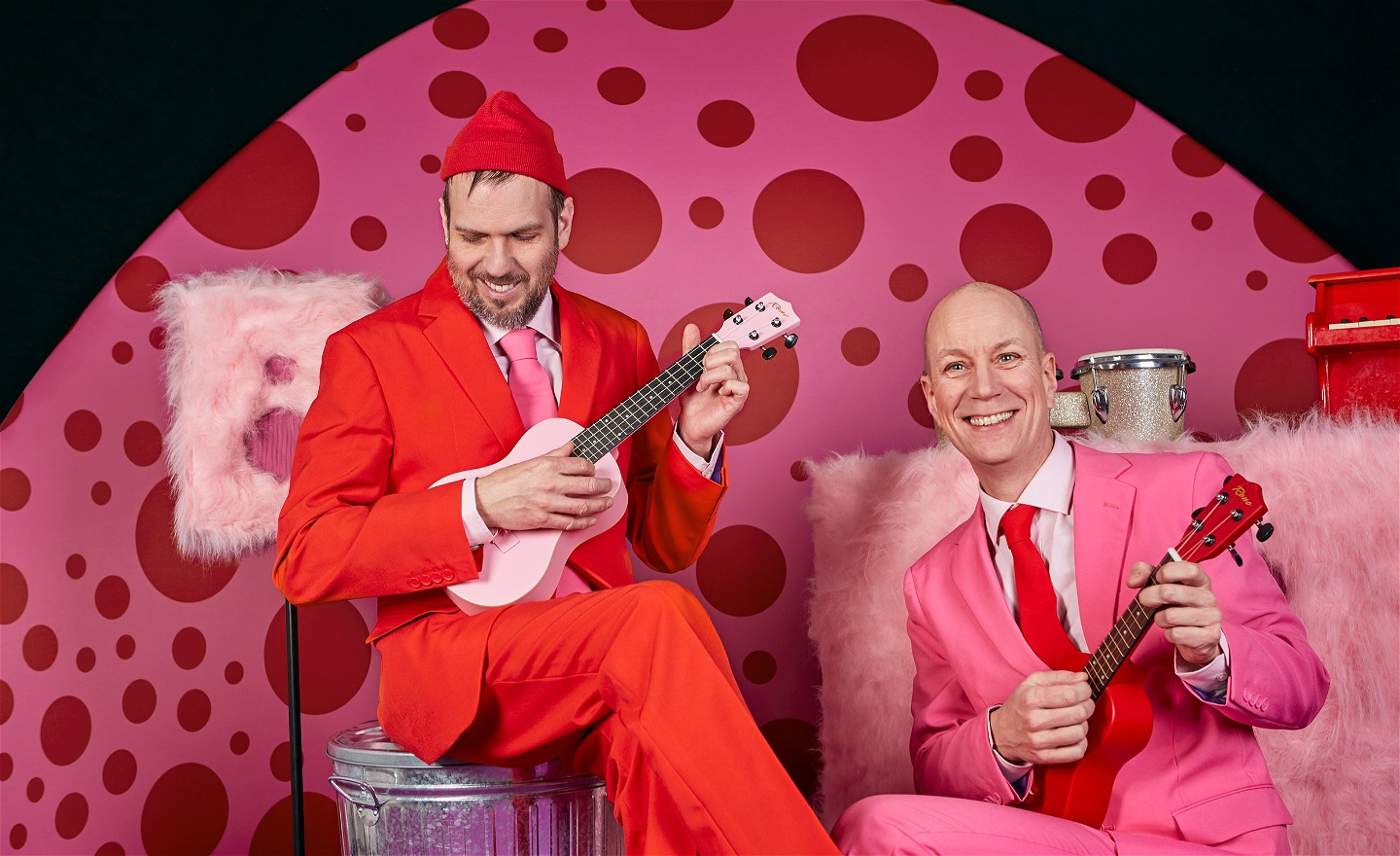 Fredrik Myhr och Per Wernolf i den färgsprakande scenografin. De spelar på varsin ukulele. 