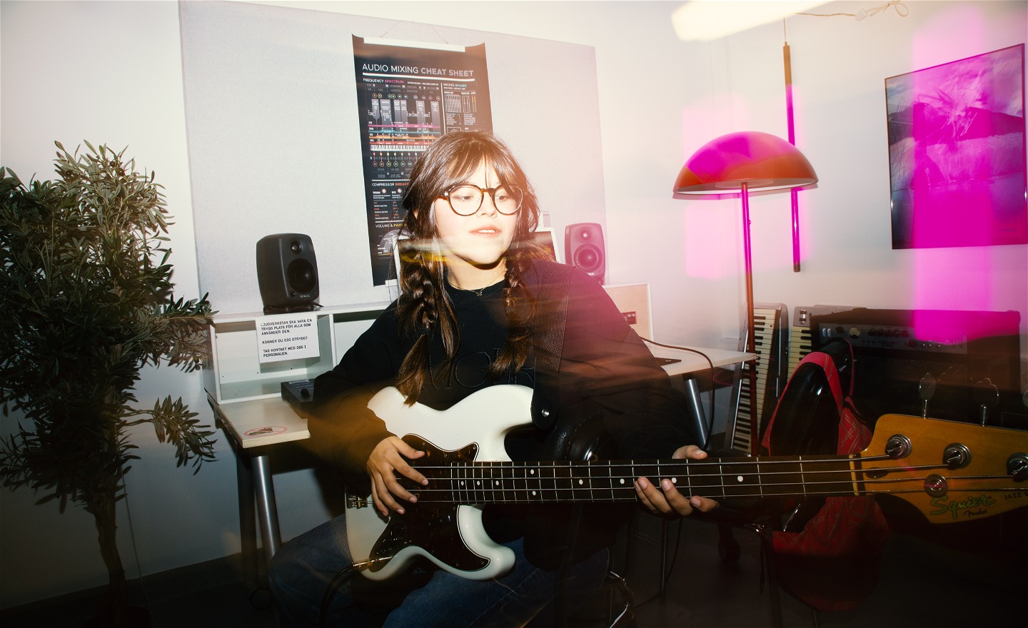 En ung person spelar bas i ljudstudion på bibliotek Lava
